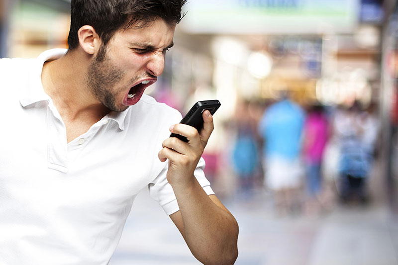Man yelling angrily at his phone